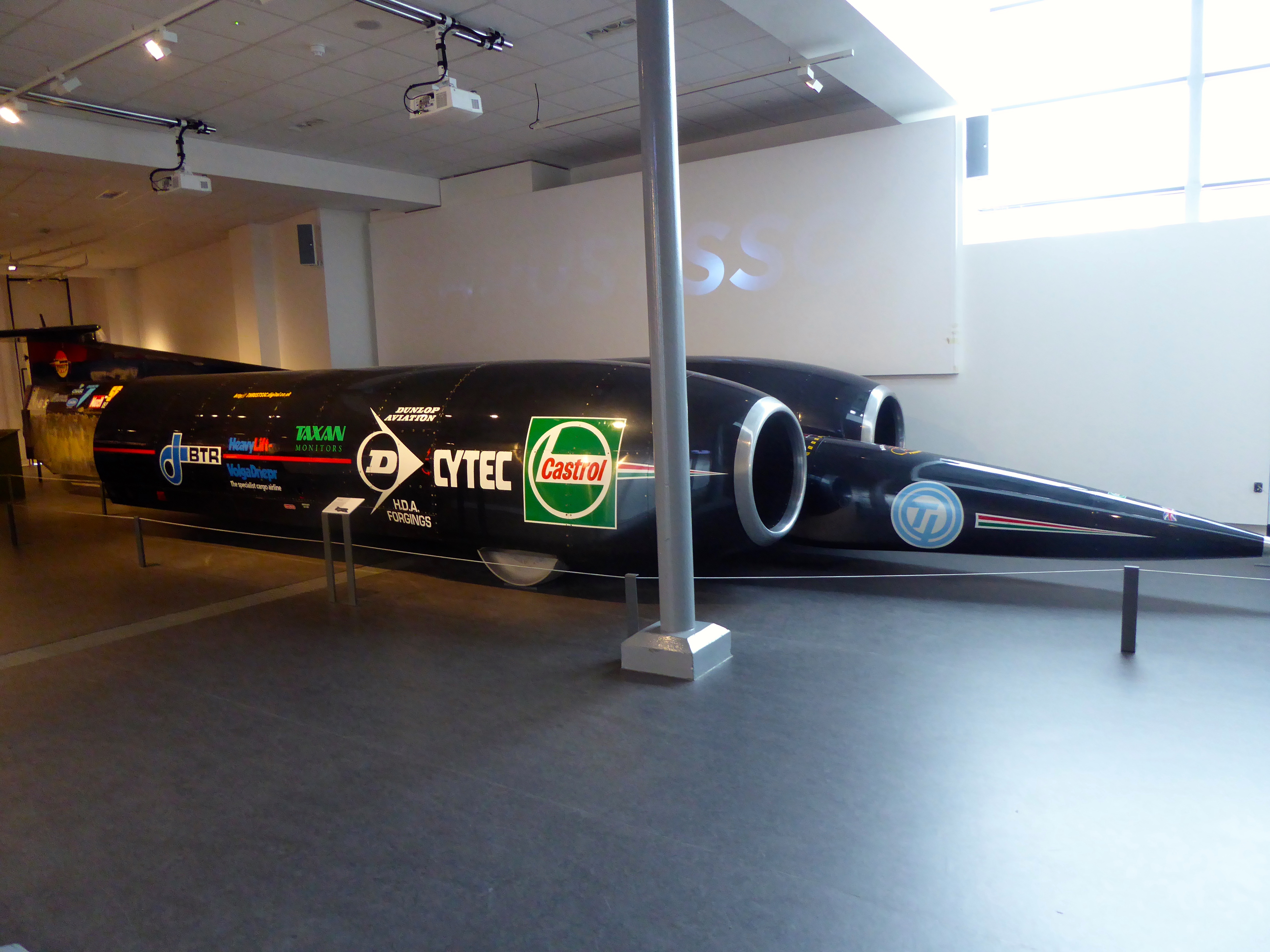 Thrust SSC.  SSC stands for Super Sonic Car.  It lived up to its name as it was the first car to go through the sound barrier.  It achieved a speed of Mach 1.03
